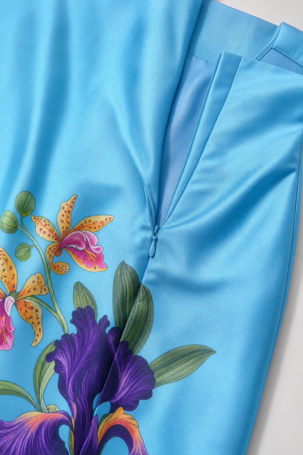 Close-up of blue dress fabric and floral hem detail