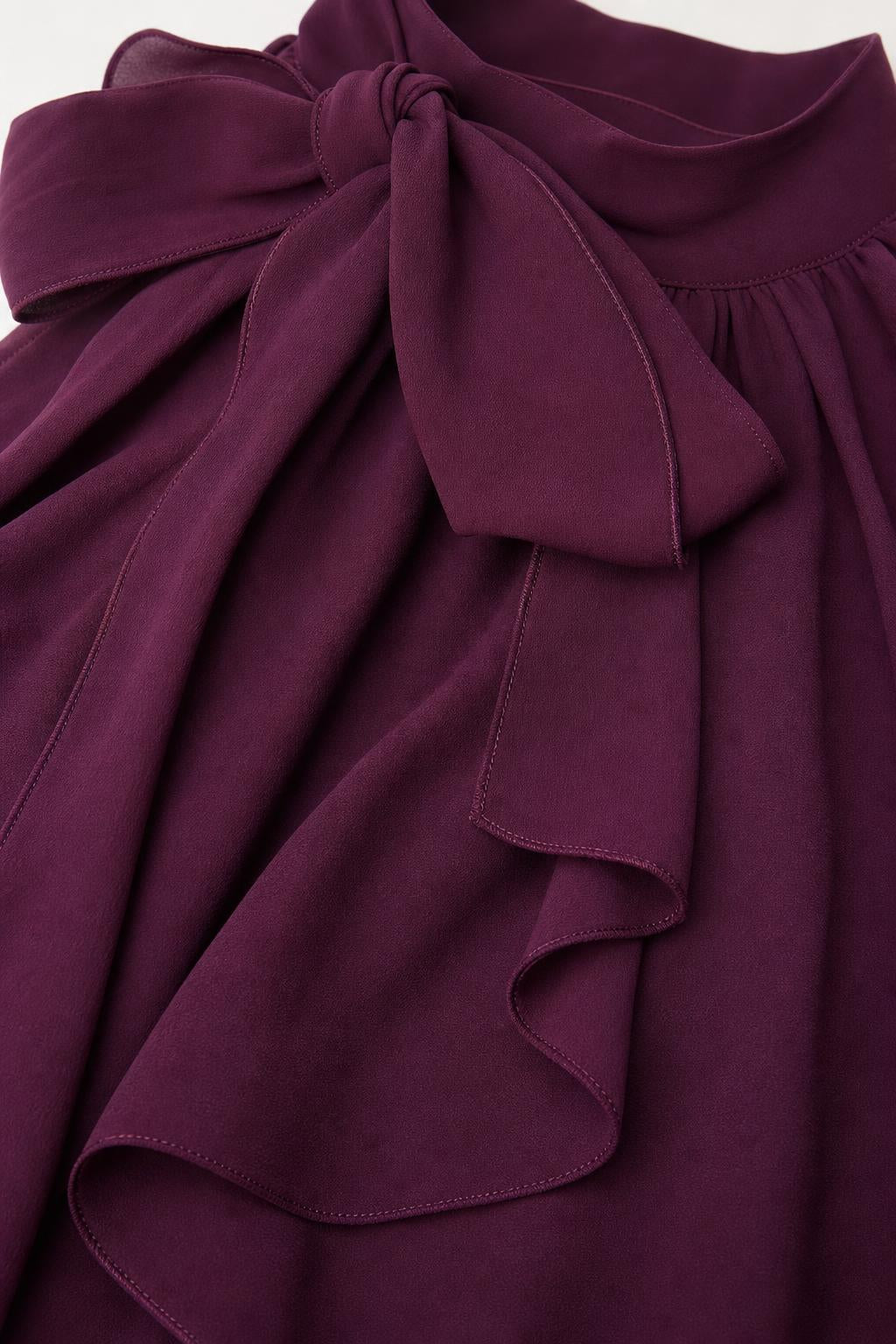Close up of purple shoulder bow and chiffon fabric texture