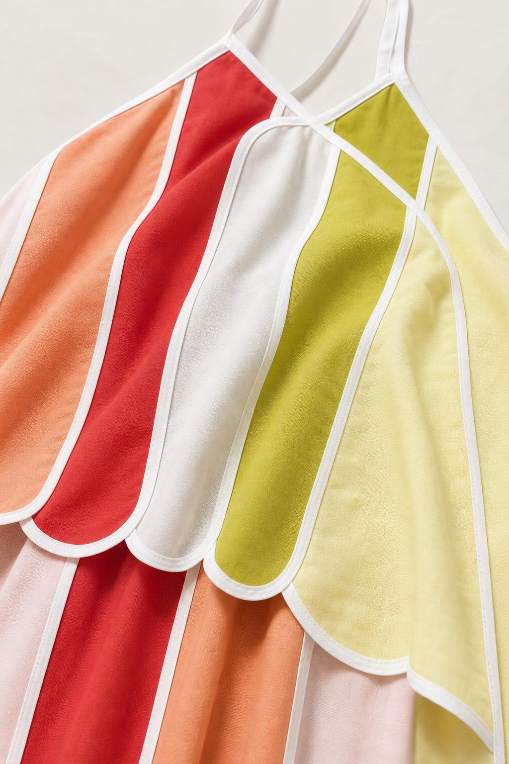 Close up of fabric and scalloped trim details on multicolor dress