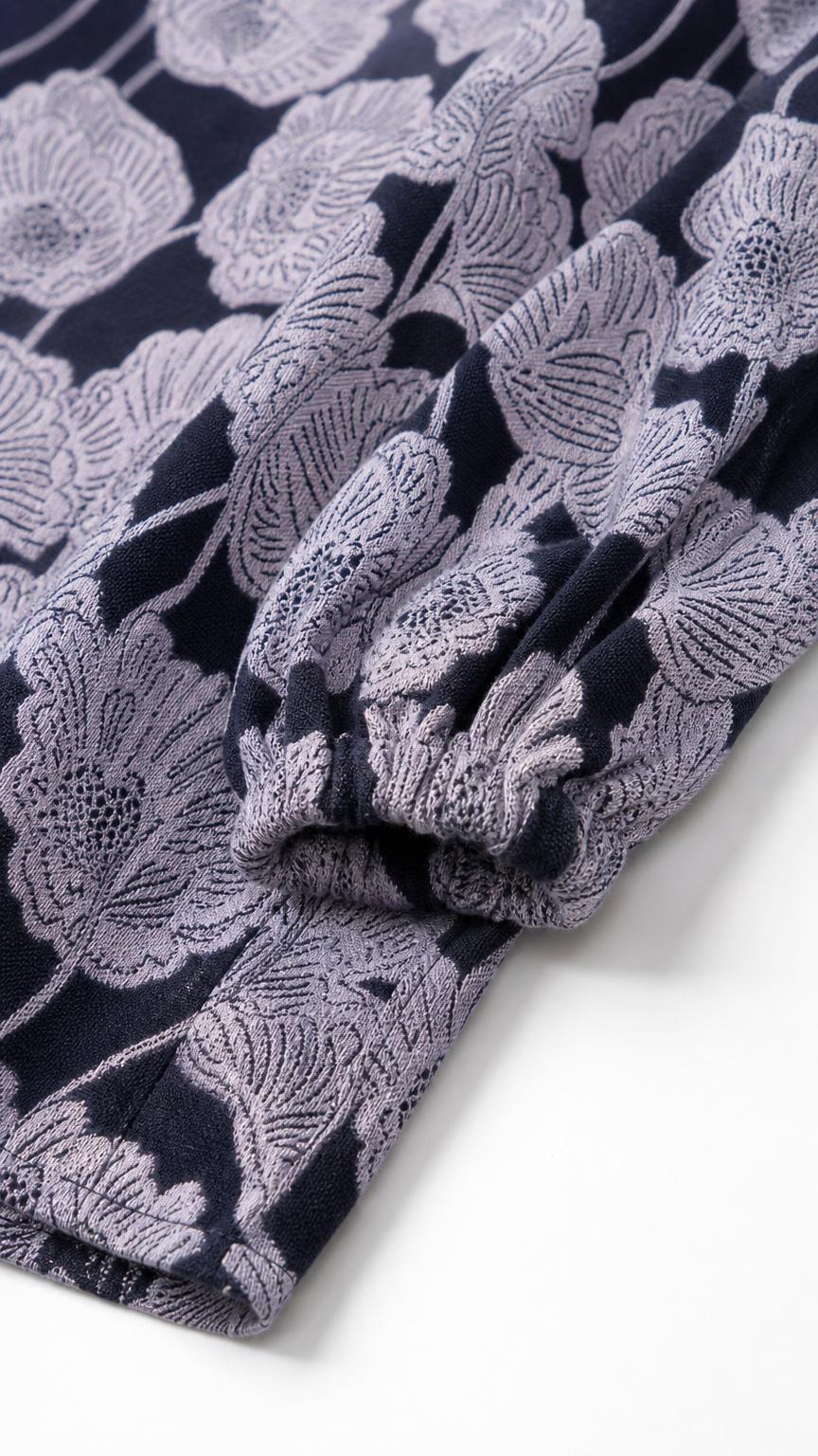 Close-up detail of the sleeve cuff and textured fabric pattern