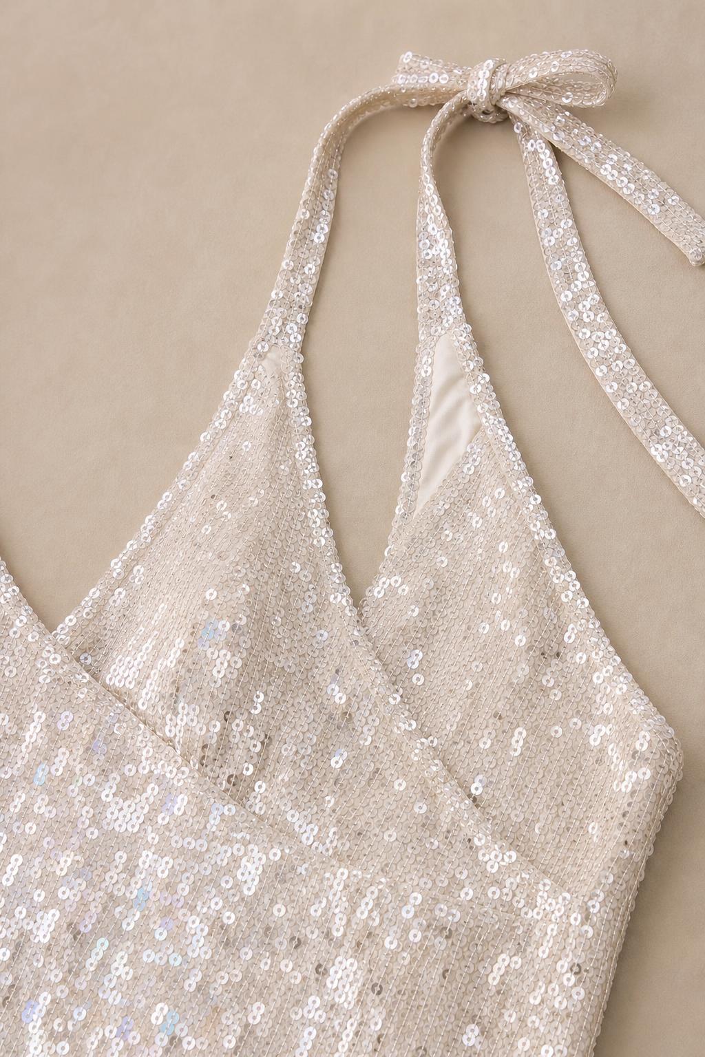 Close-up detail of white sequin halter neckline and straps