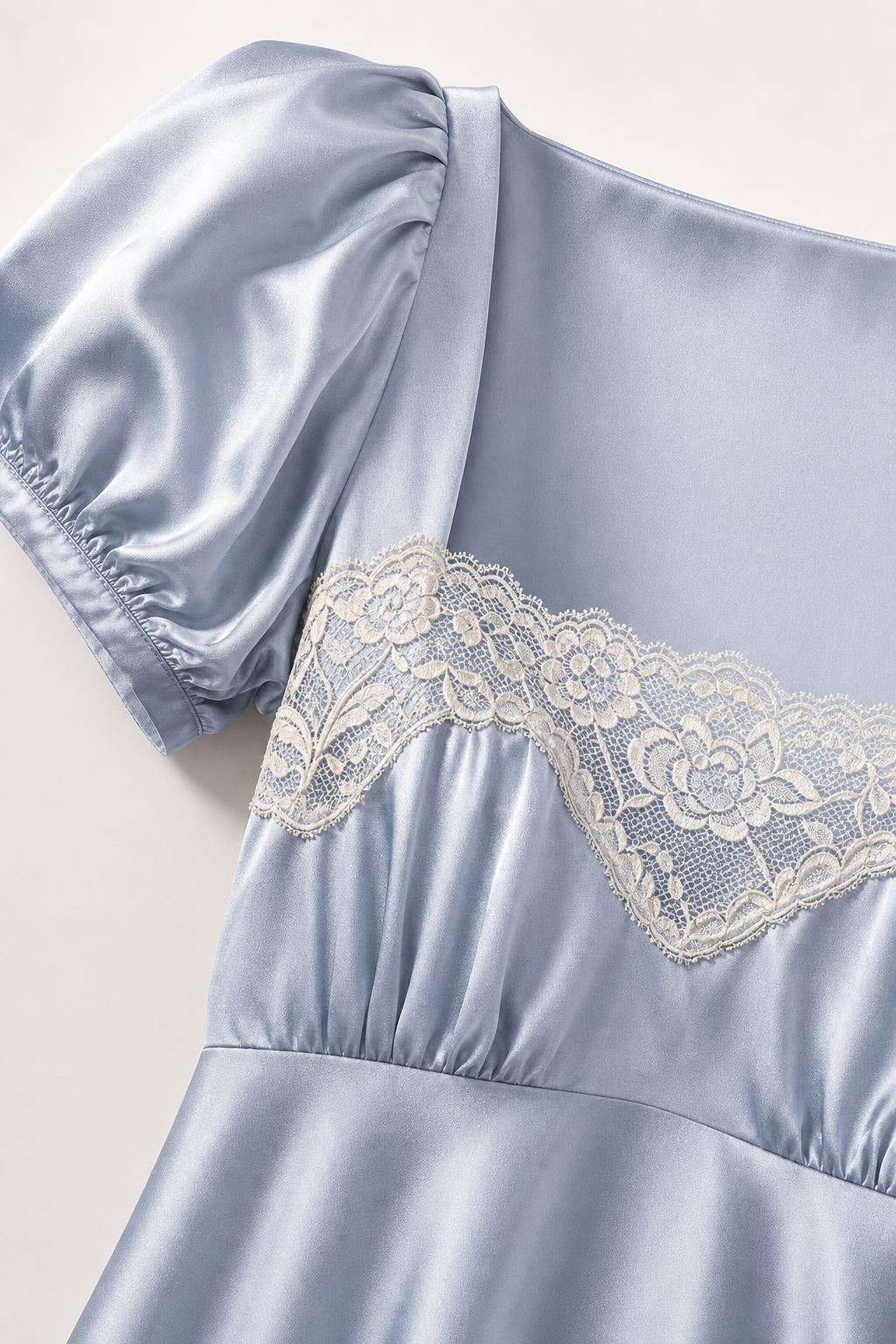 Close-up detail of square neck and lace bodice on light blue satin dress