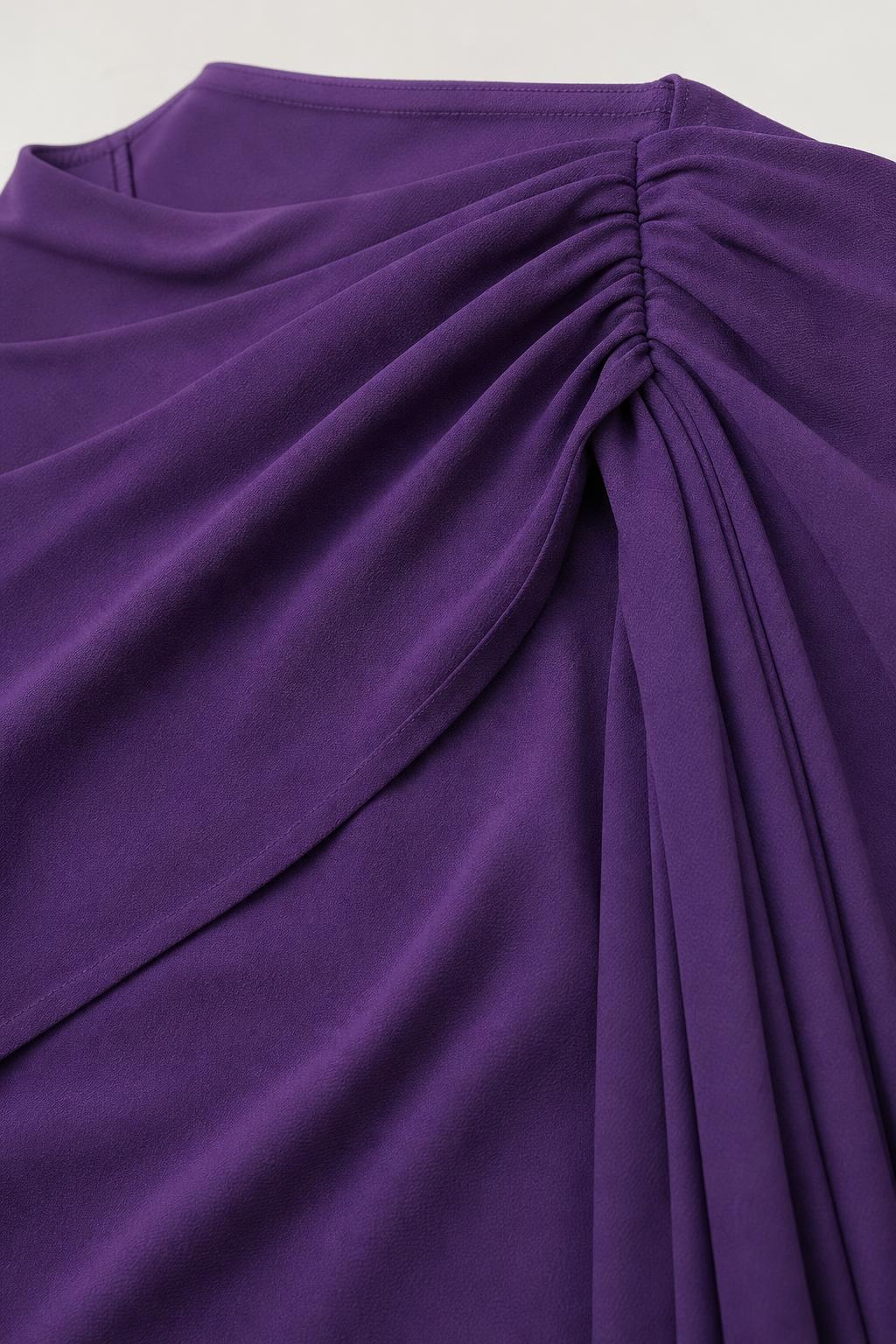 Close up of gathered fabric detail on purple dress