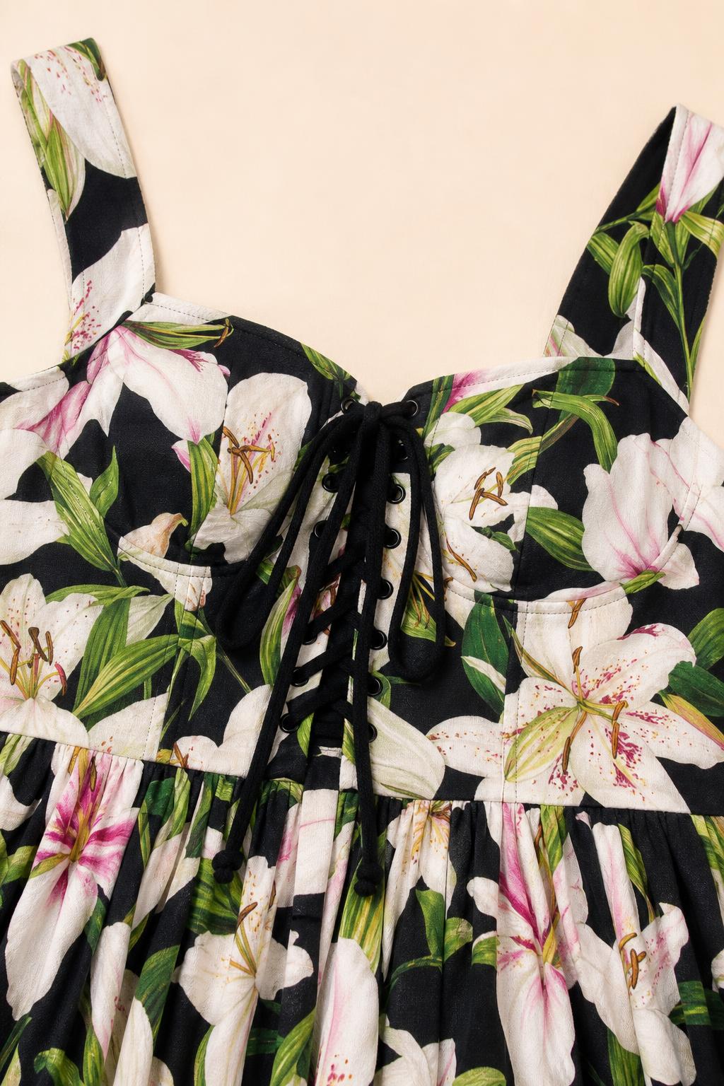 Close-up detail of lace-up square neckline and floral print fabric
