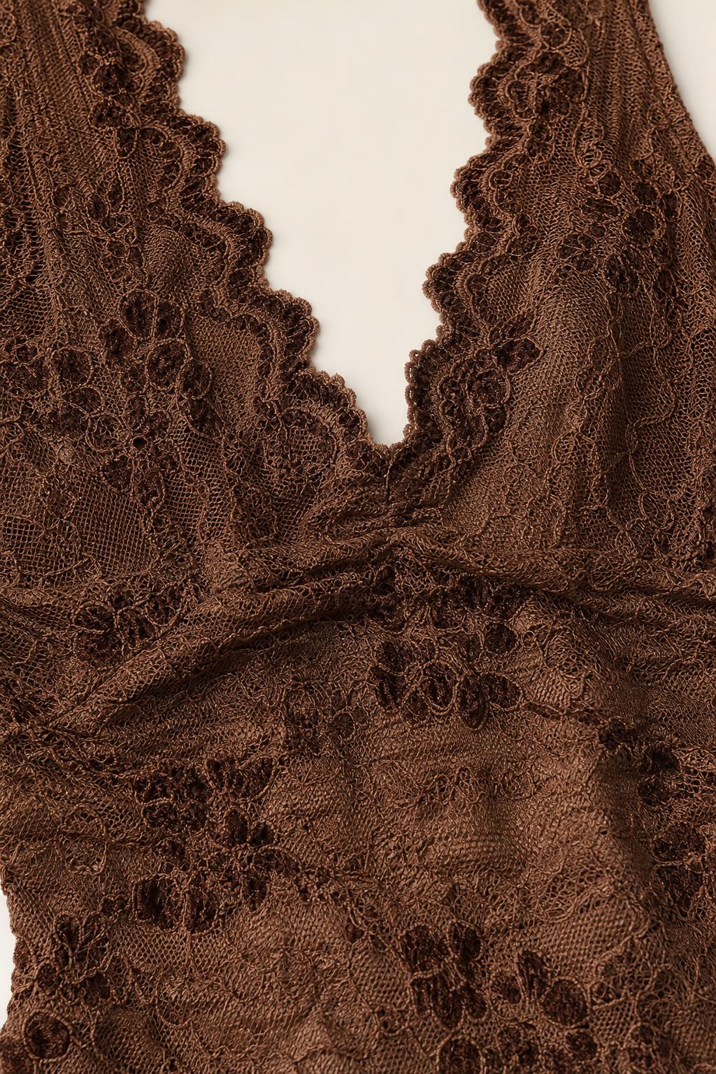 Close-up detail of V-neckline and scalloped lace trim