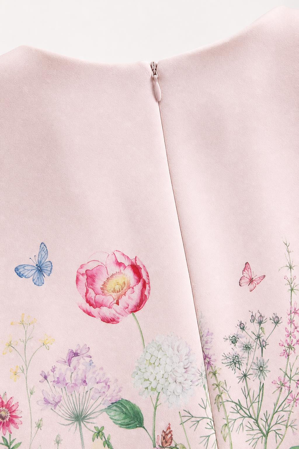 Close-up of pink dress showing floral print and back zipper detail
