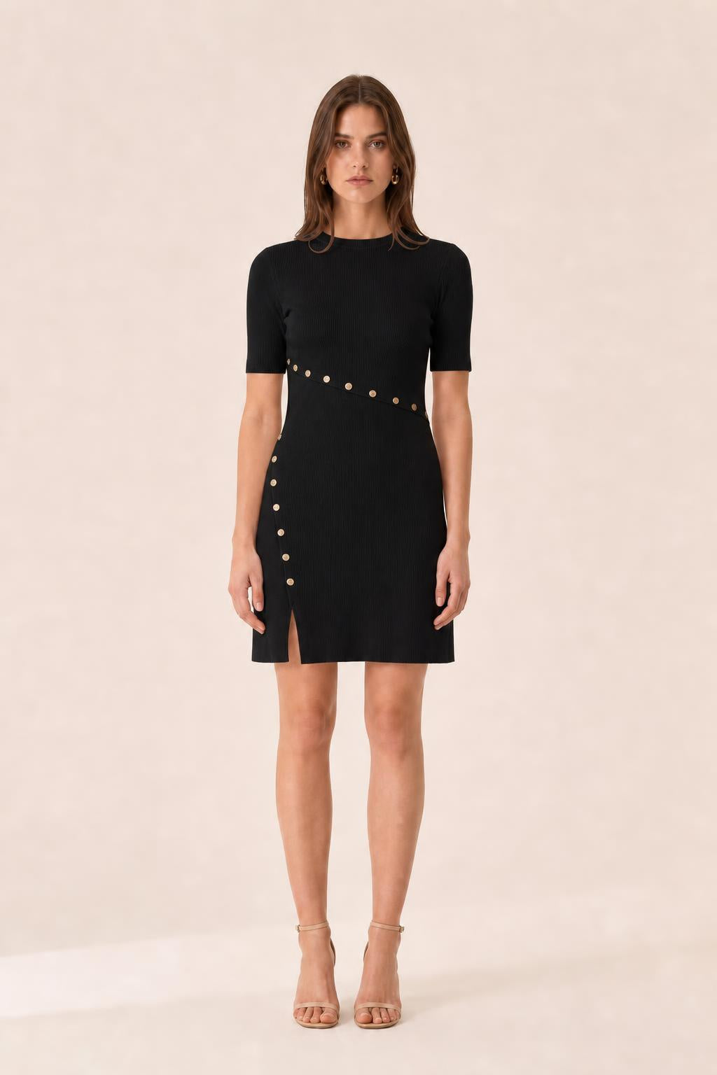 Front view of woman wearing black ribbed knit mini dress