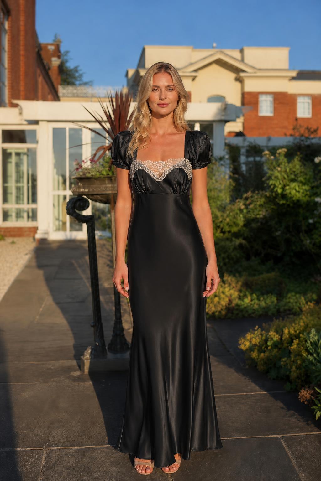 Front view of black satin lace trim maxi dress on model