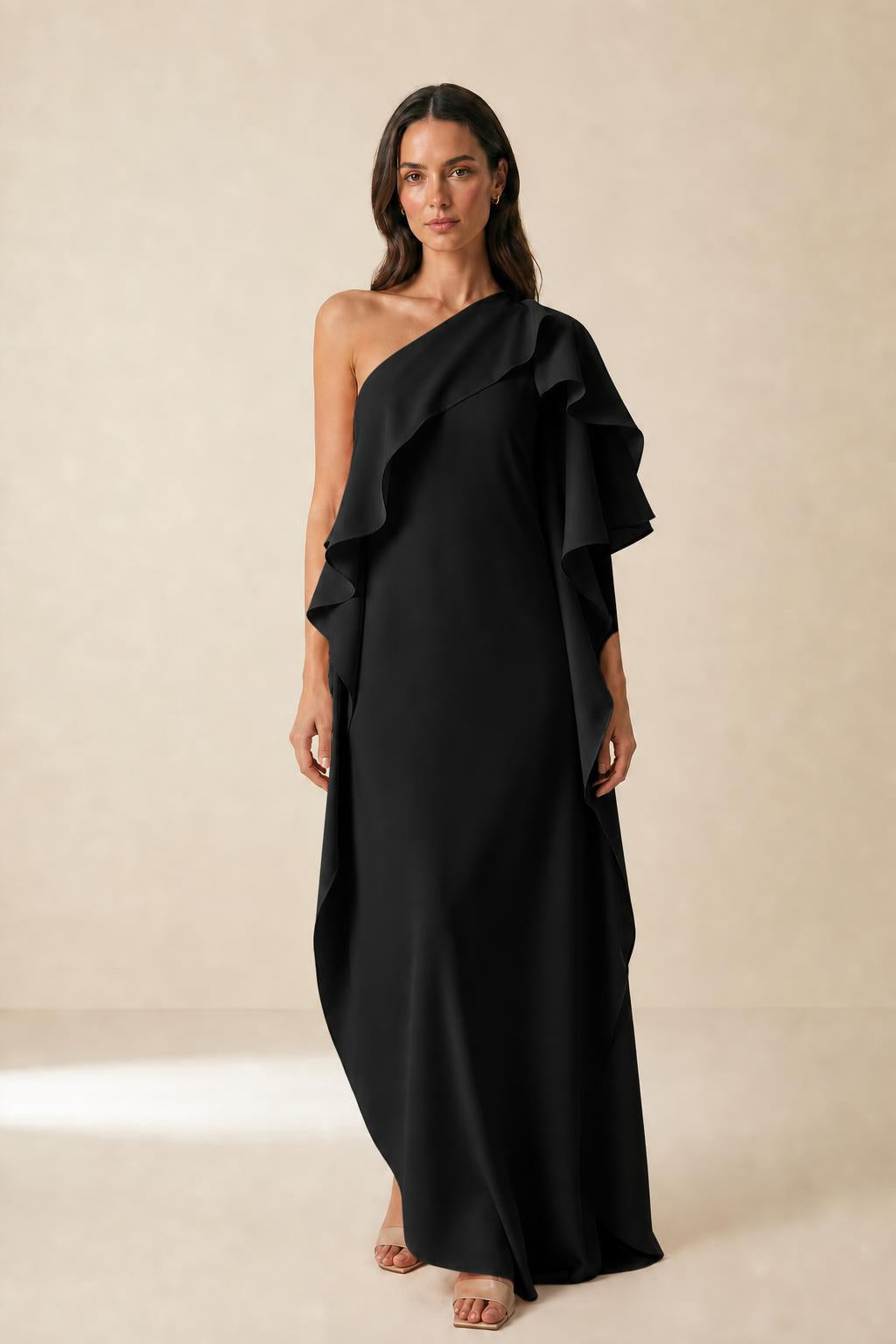 Front view of model wearing black one-shoulder ruffle maxi dress