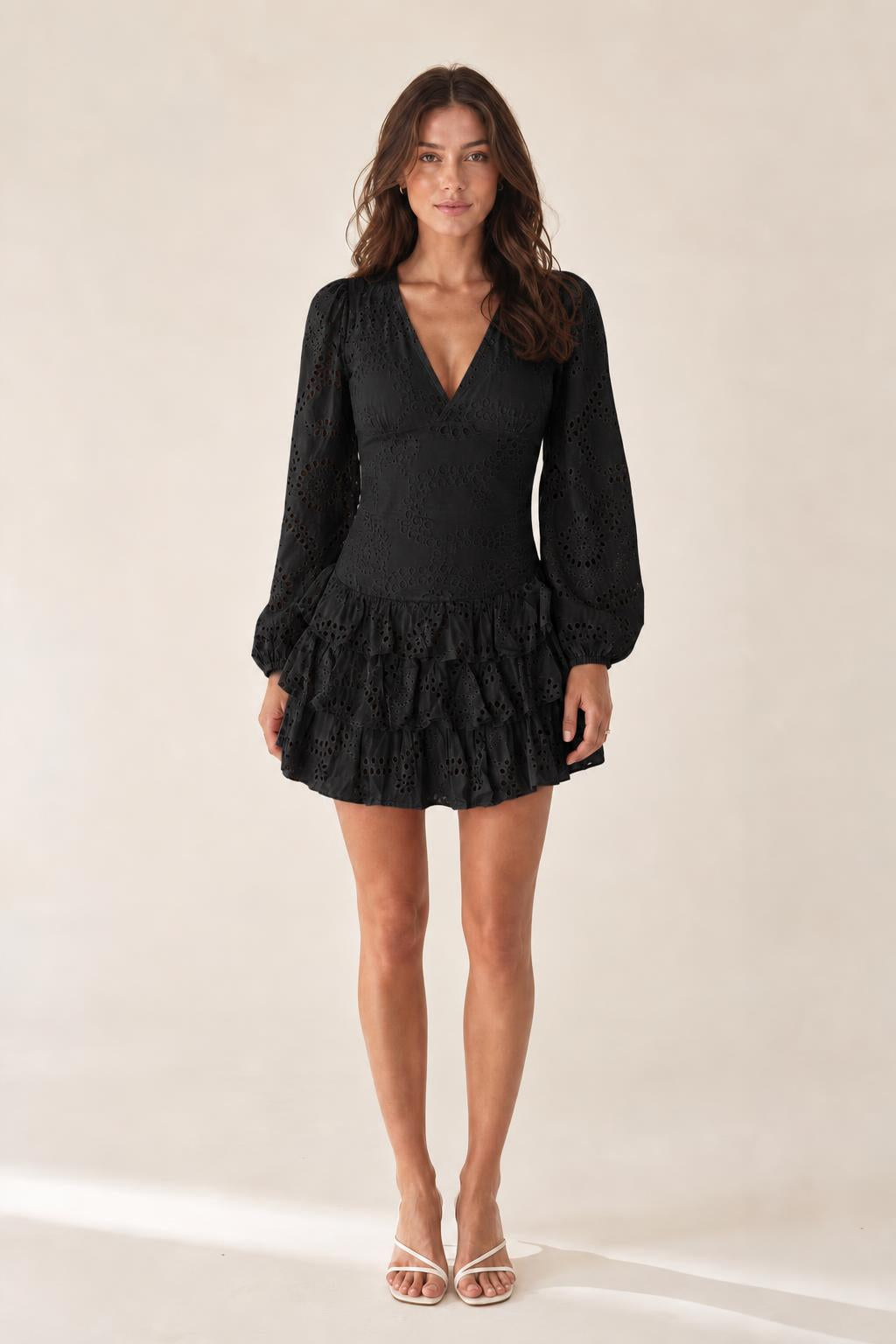 Front view of model wearing black eyelet mini dress
