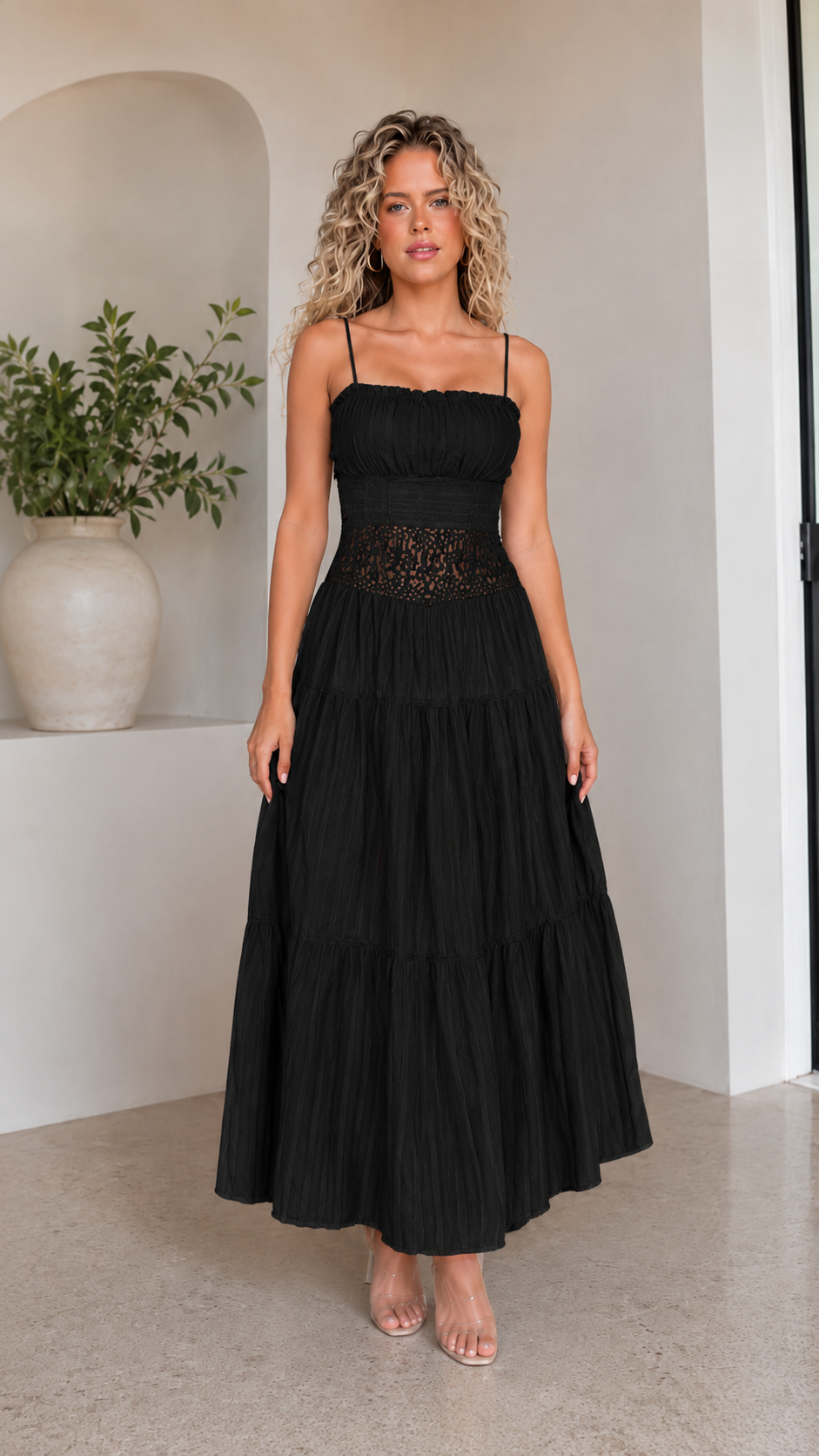 Front view of black spaghetti strap tiered maxi dress with lace-look waist detail