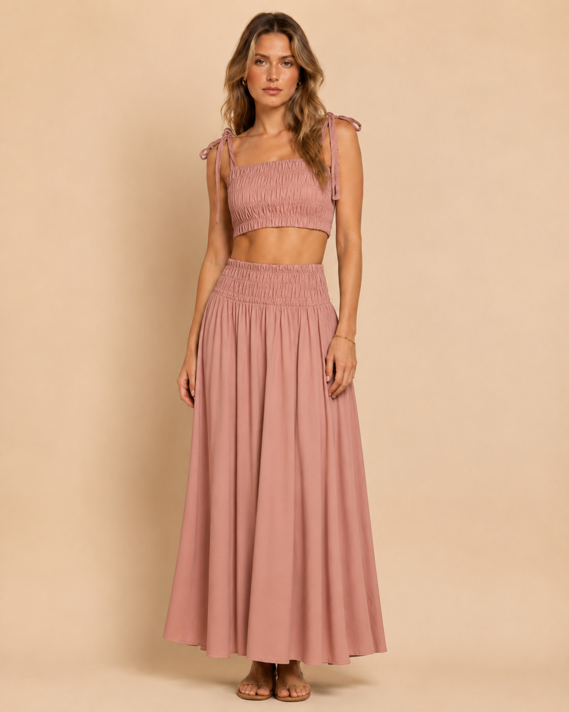 Front view of dusty rose smocked tie-shoulder crop top and matching maxi skirt set