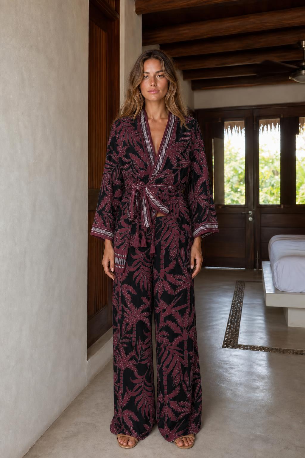 Front view of black floral wrap jumpsuit