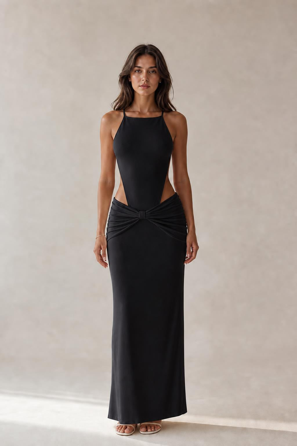 Model wearing black cut-out ruched maxi dress