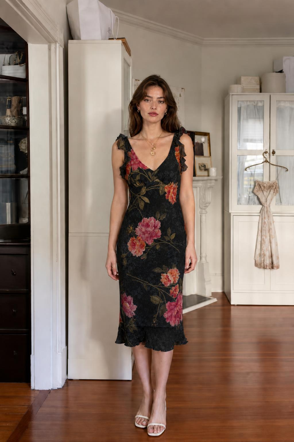 Front view of woman wearing black floral midi dress