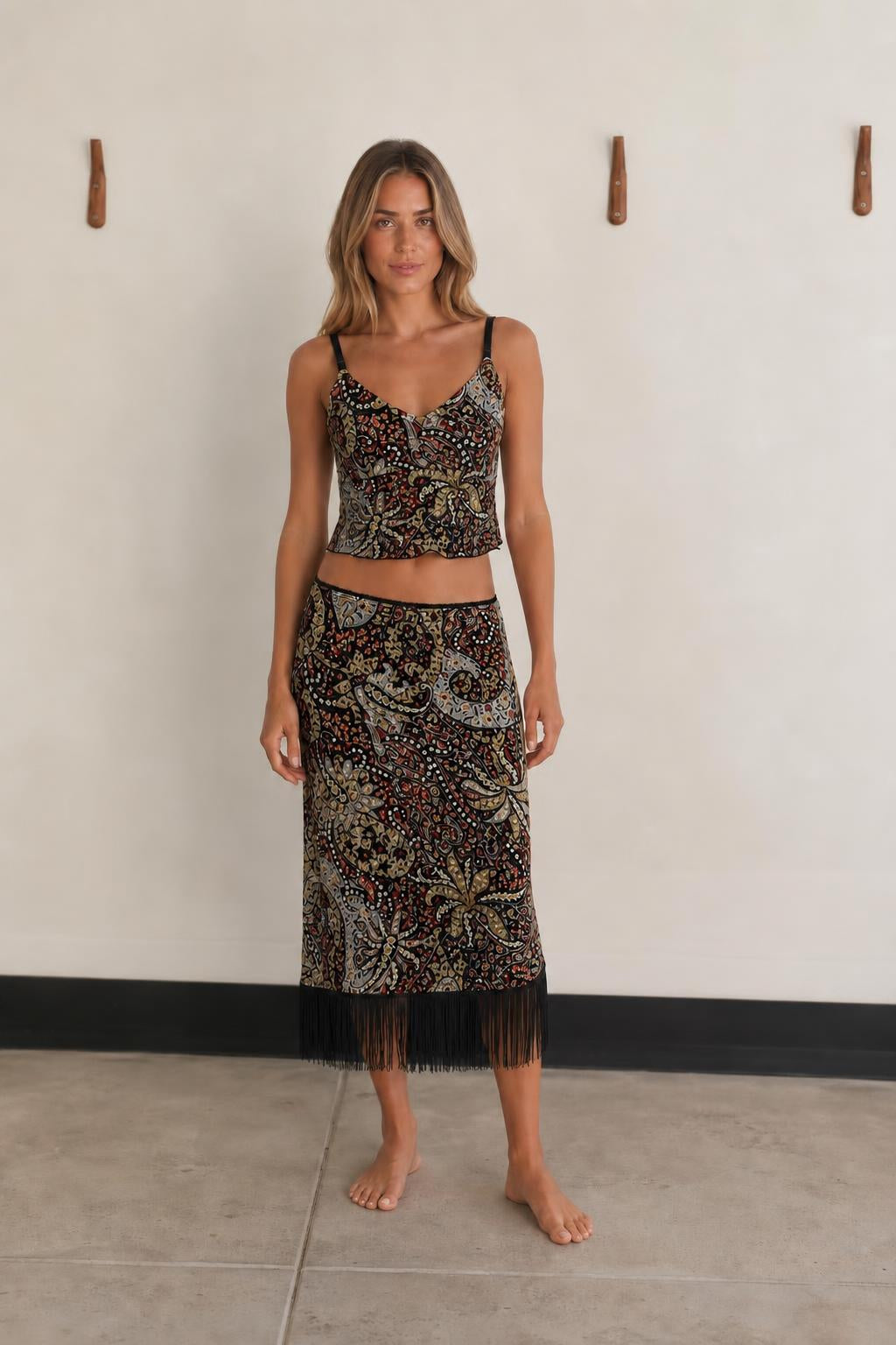 Front view of woman wearing Black Multi paisley crop top and fringe skirt set