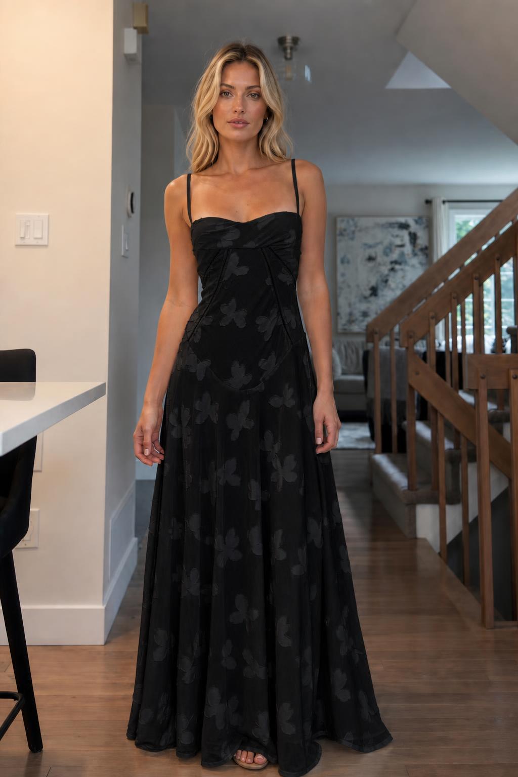 Front view of woman wearing black floral jacquard maxi dress