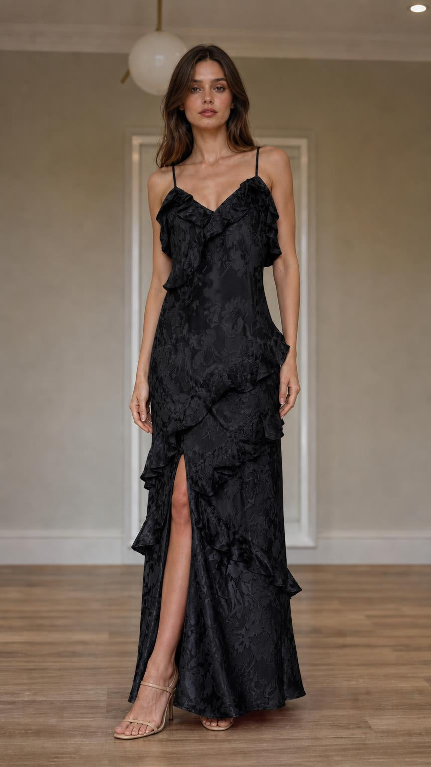 Front view of model wearing black ruffled slip maxi dress