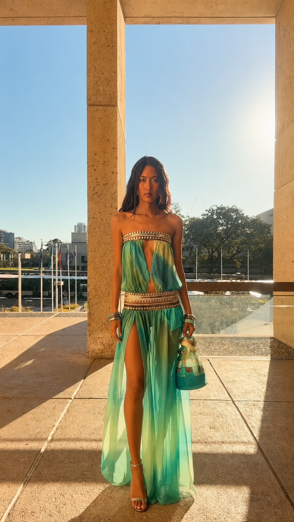Front view of aqua strapless embellished maxi dress with high slit