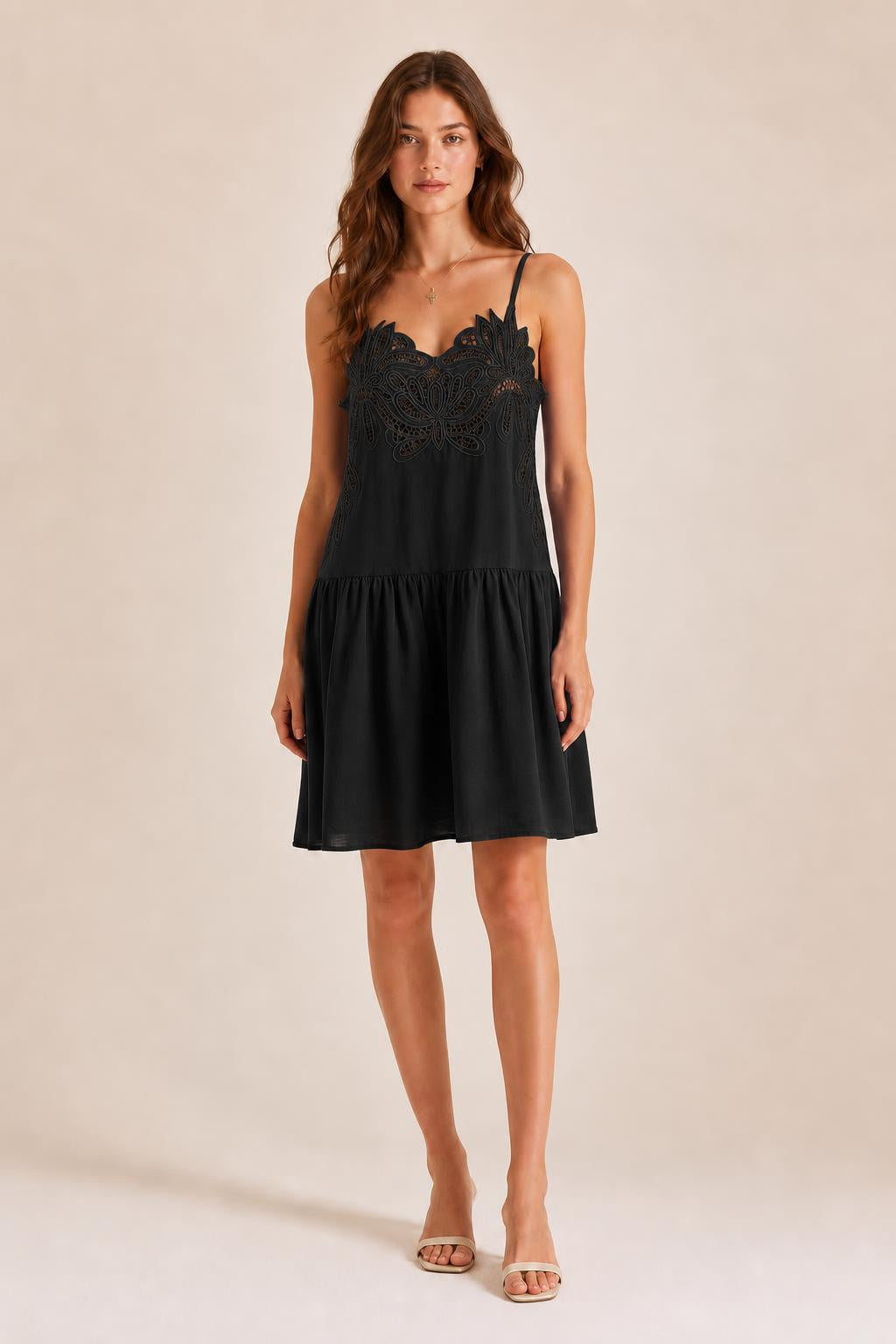 Front view of model in Black embroidered cami mini dress