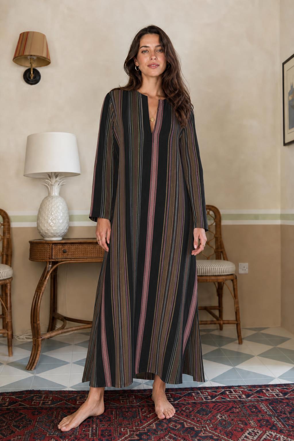 Model wearing black vertical stripe long sleeve maxi dress
