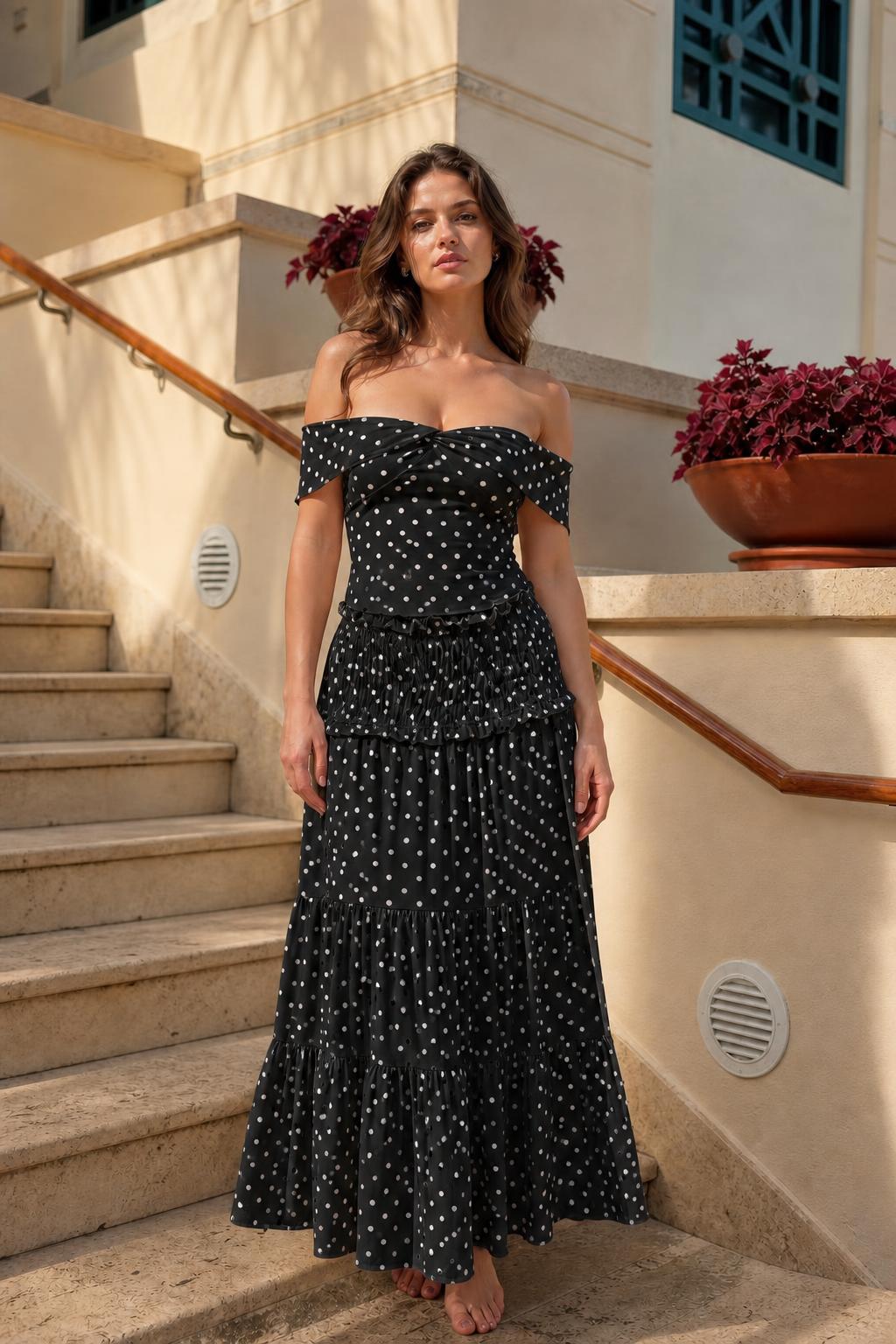 Model wearing black polka dot off-the-shoulder maxi dress