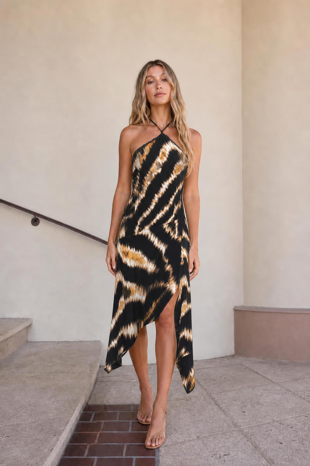 Front view of black printed halter midi dress