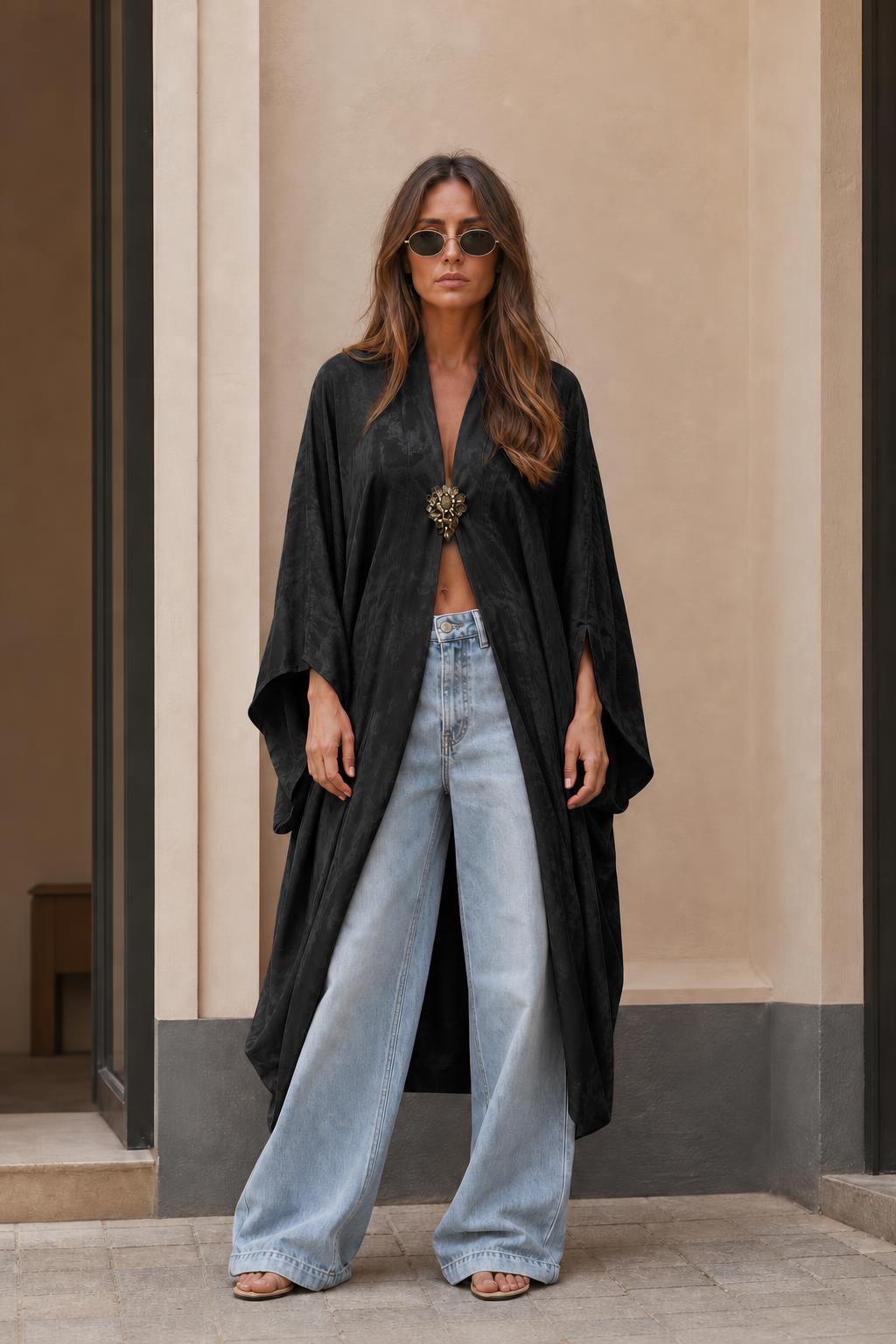 Model wearing black long kimono cardigan with open front