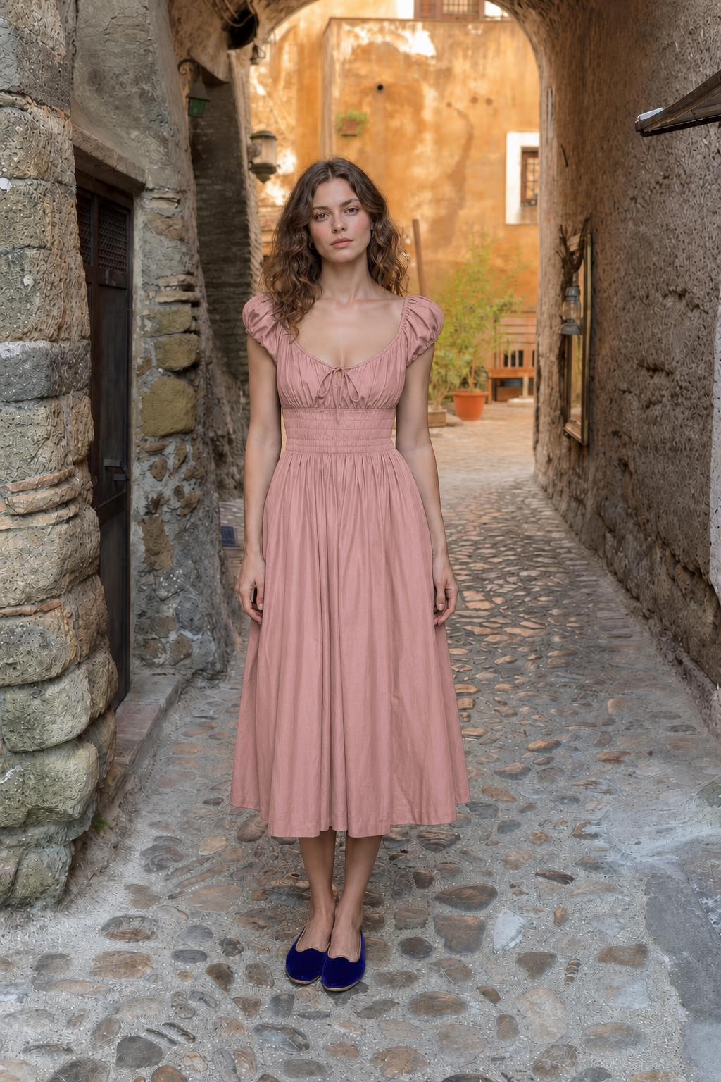 Front view of woman wearing dusty rose smocked midi dress