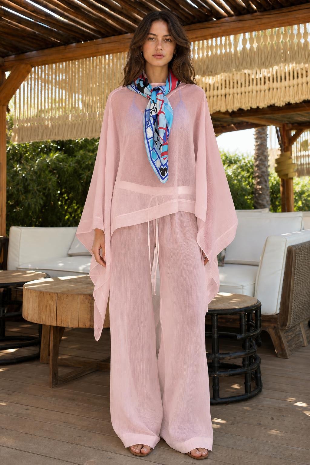 Model wearing soft pink two-piece kaftan and wide-leg pants set