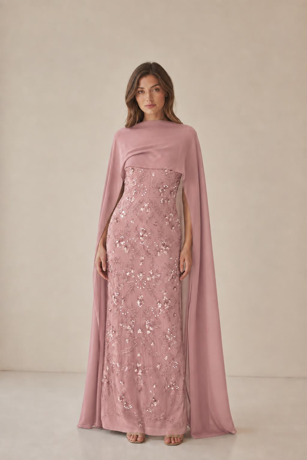 Model wearing dusty rose cape maxi dress