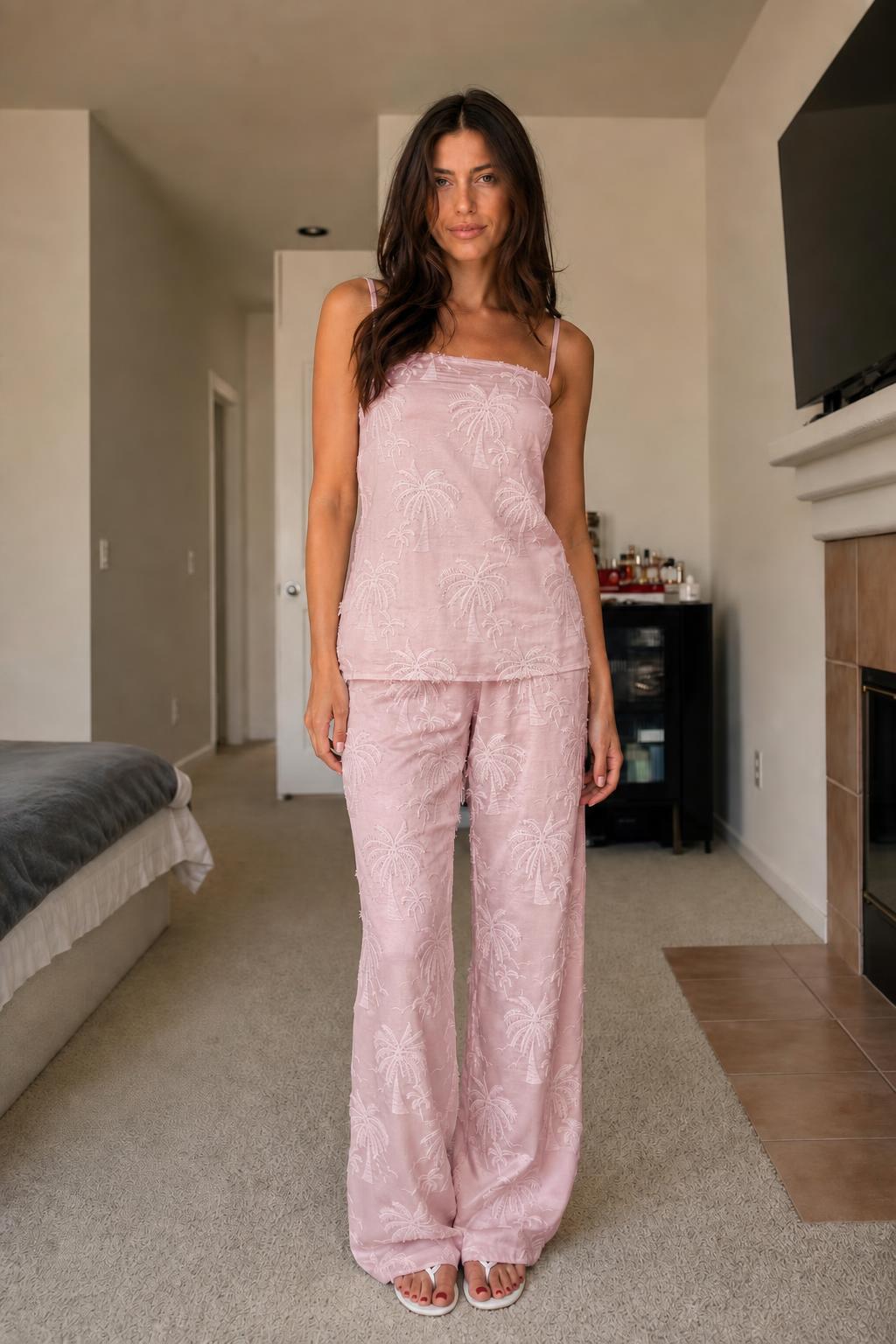 Front view of woman wearing pink palm embroidered two-piece set