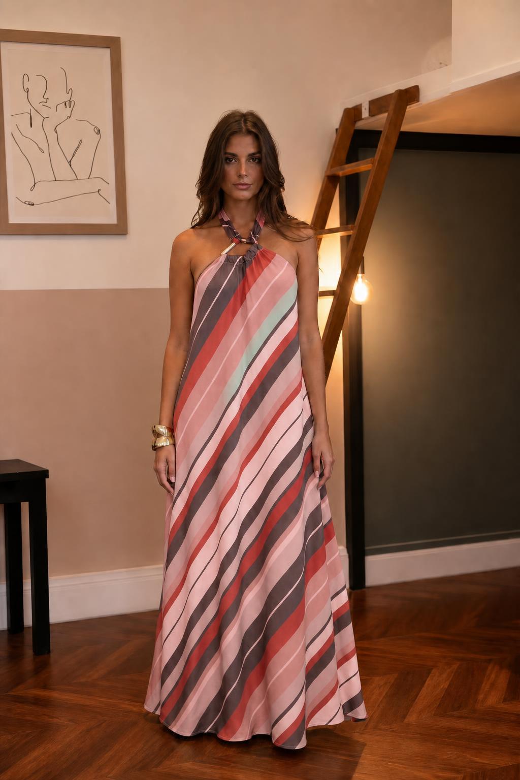 Woman wearing pink striped halter maxi dress