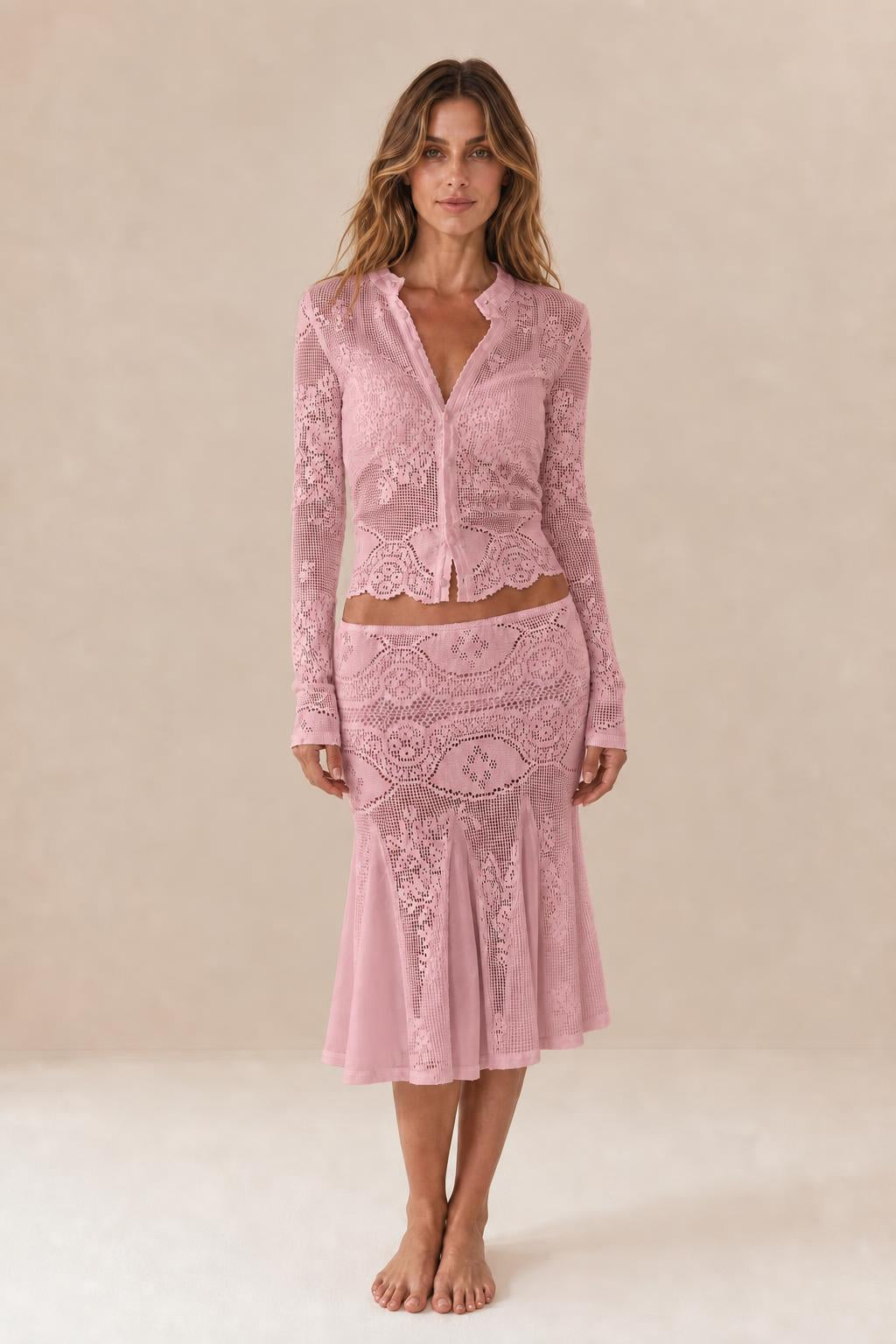 Front view of woman wearing pink crochet lace two-piece set