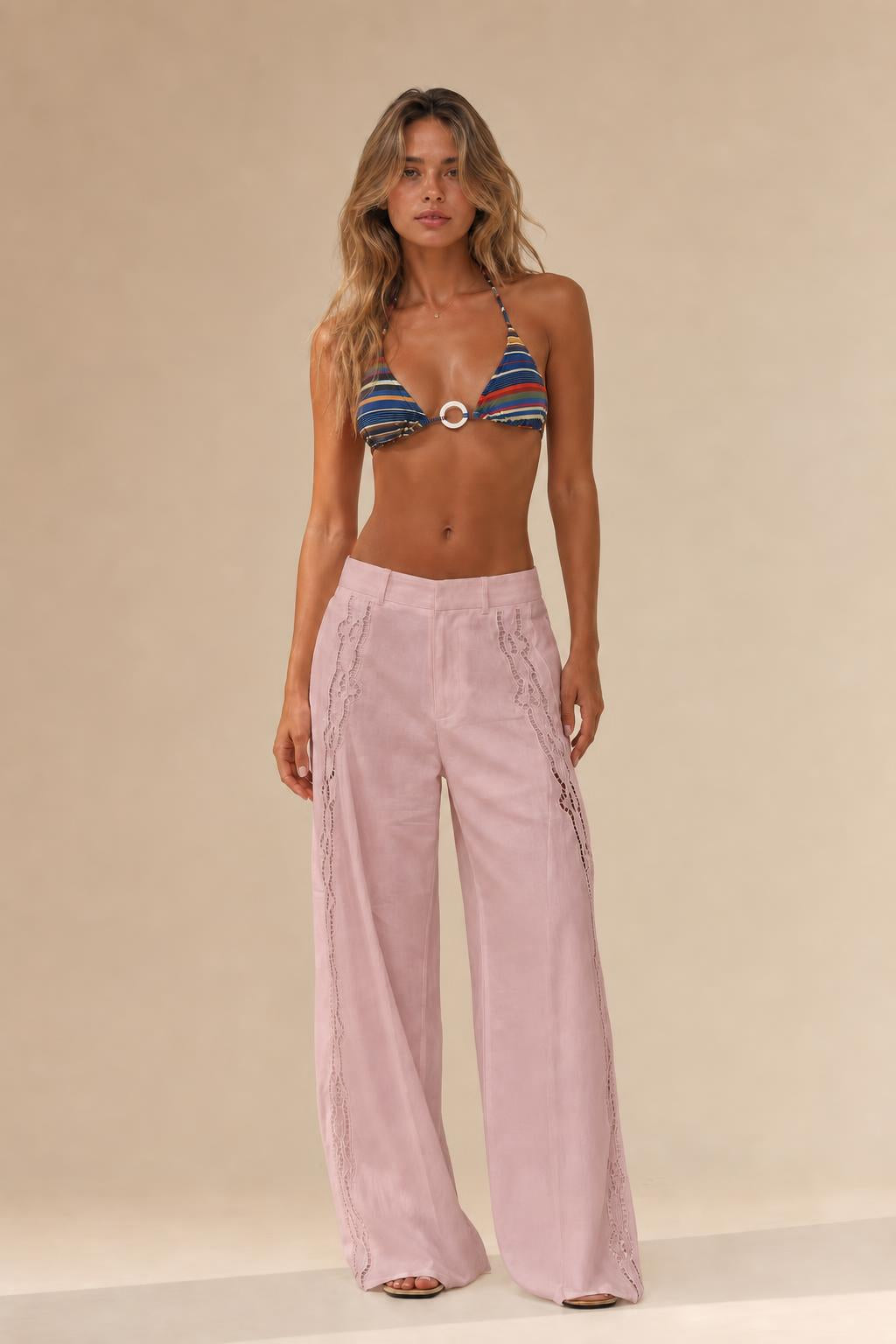 Woman wearing pink cutout wide leg trousers