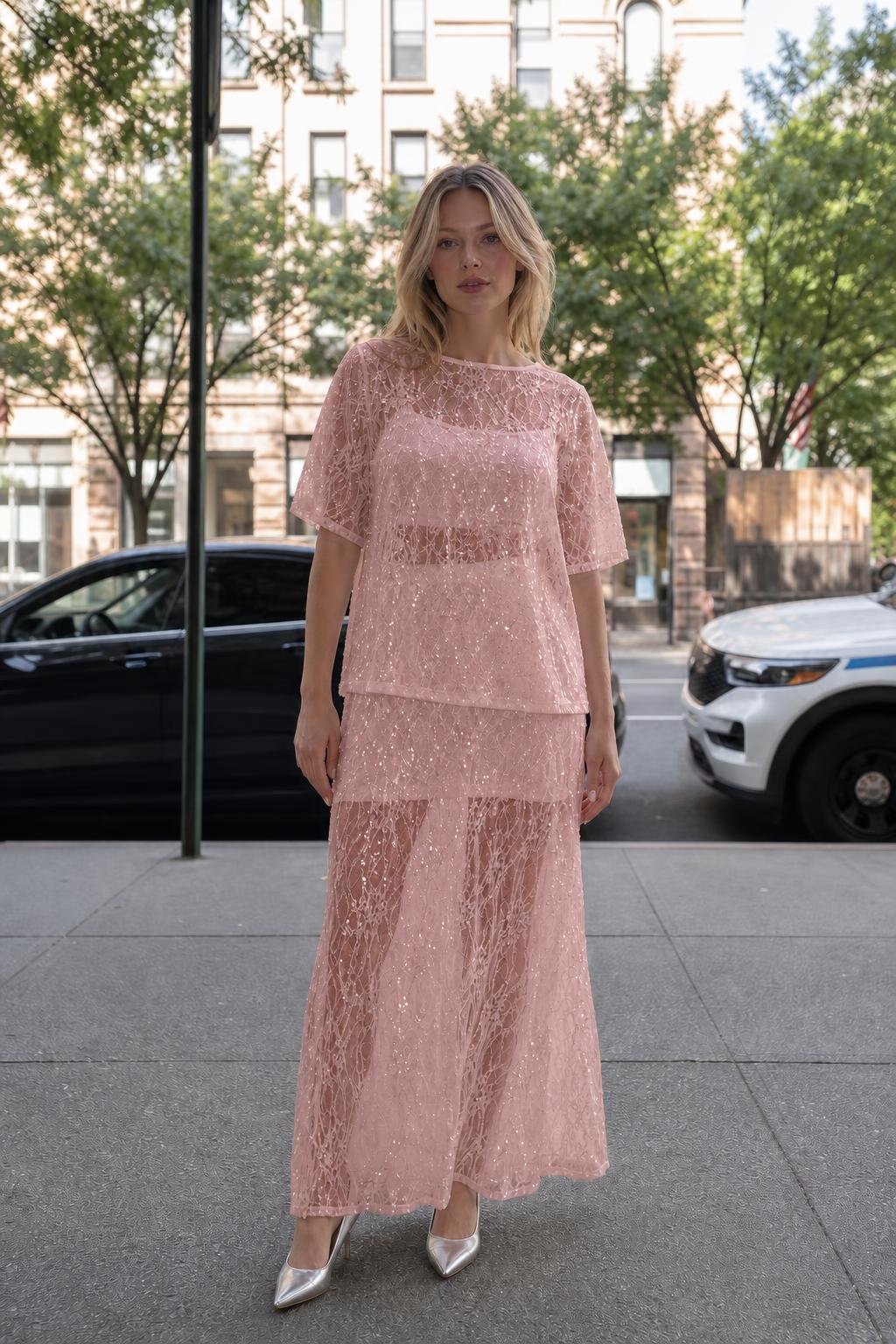 Woman wearing pink sheer sequin lace two-piece set