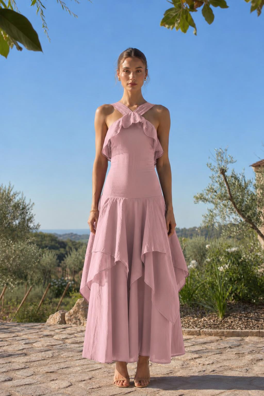 Front view of woman wearing pink halter neck ruffled maxi dress