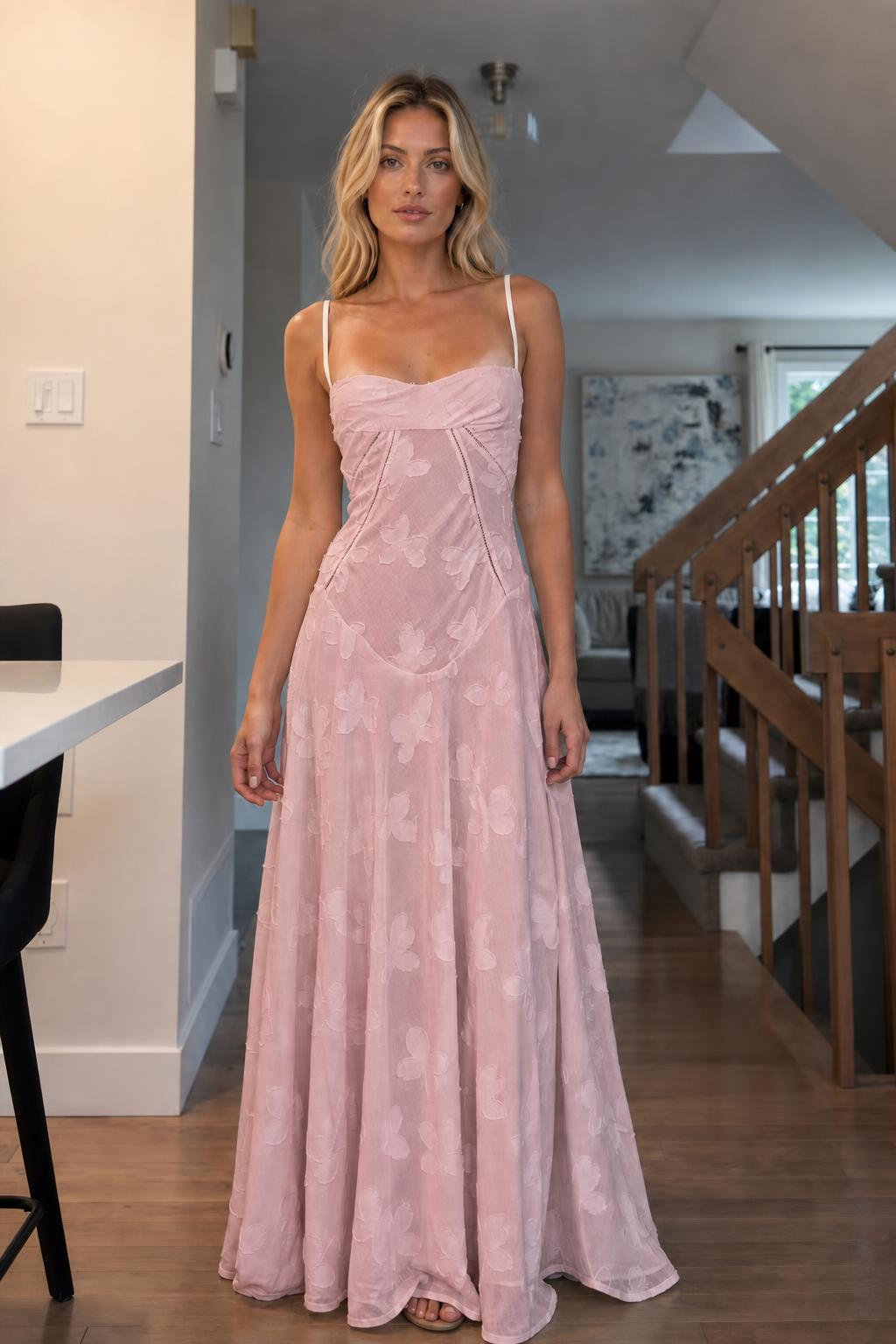 Front view of woman wearing pink floral jacquard maxi dress