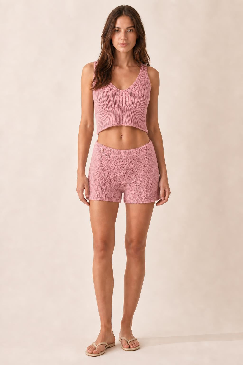 Model wearing pink ribbed knit crop tank and shorts set