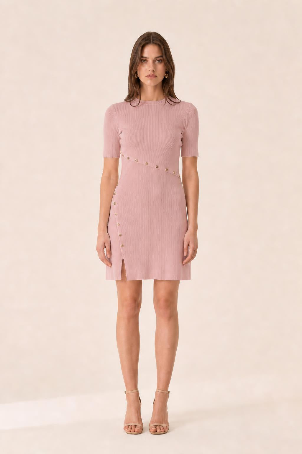 Front view of woman wearing pink ribbed knit mini dress
