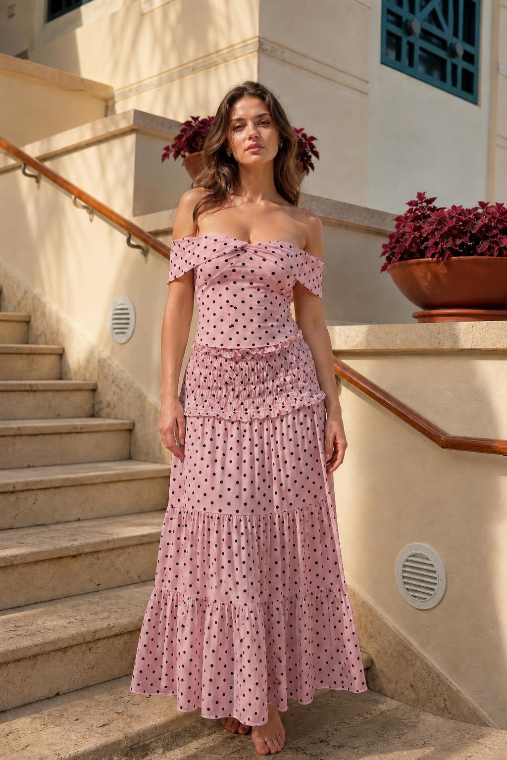 Model wearing pink polka dot off-the-shoulder maxi dress