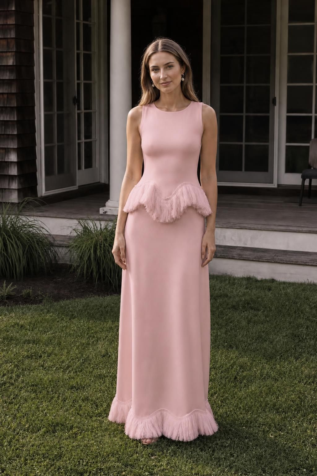 Front view of model wearing pink fringed peplum maxi dress