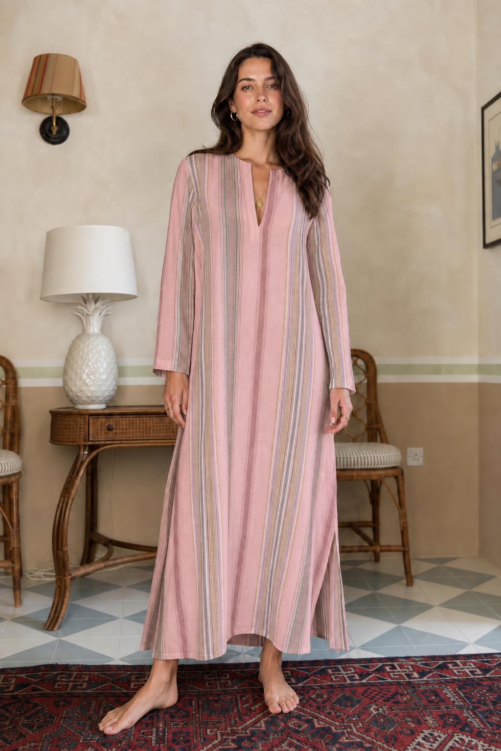 Model wearing pink vertical stripe long sleeve maxi dress