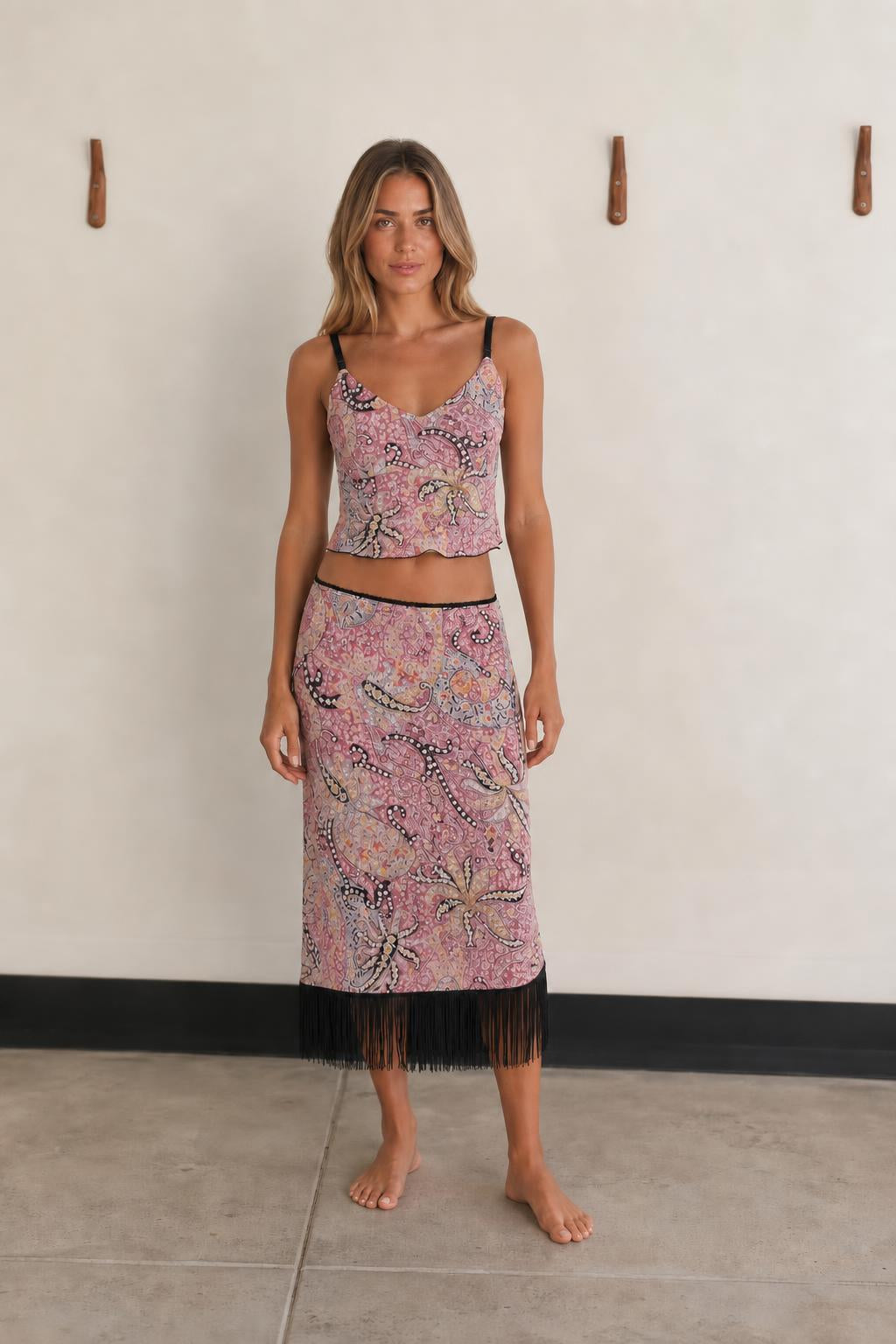 Front view of woman wearing Pink Multi paisley crop top and fringe skirt set