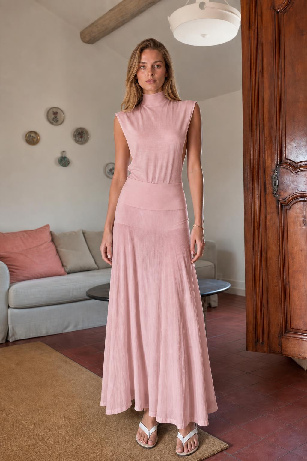 Model wearing pink sleeveless mock neck knit maxi dress