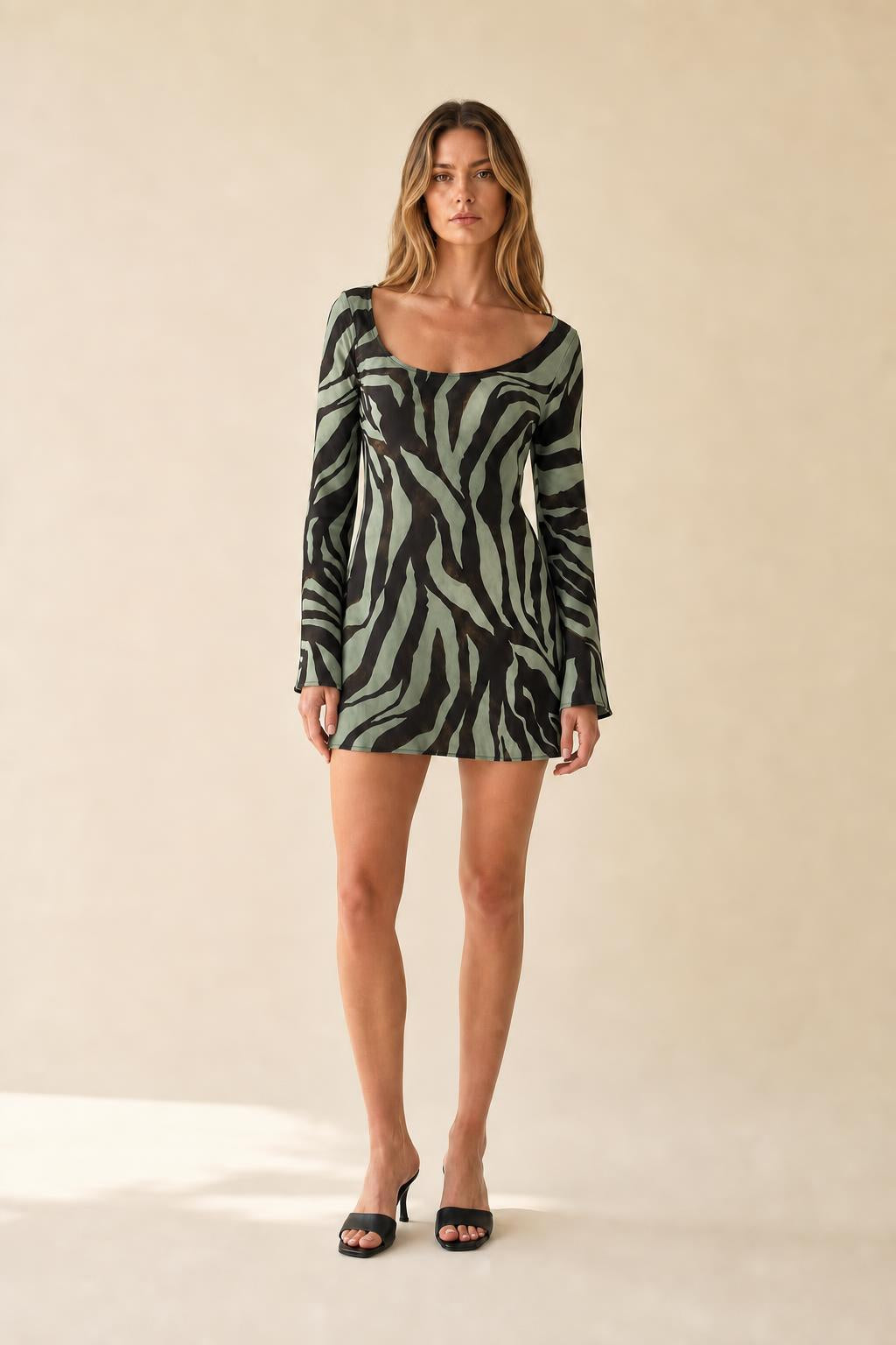 Model wearing green zebra print long sleeve mini dress