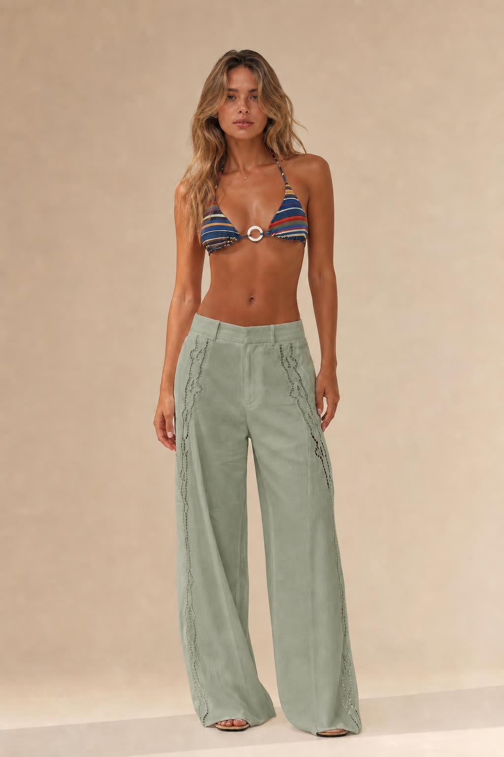 Woman wearing sage green cutout wide leg trousers