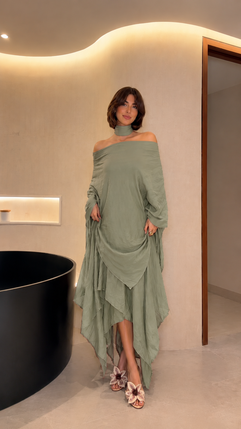 Front view of sage off-shoulder flowing maxi dress with relaxed silhouette and handkerchief hem