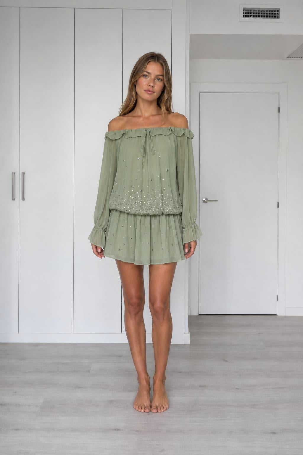 Front view of model wearing sage off-the-shoulder chiffon mini dress