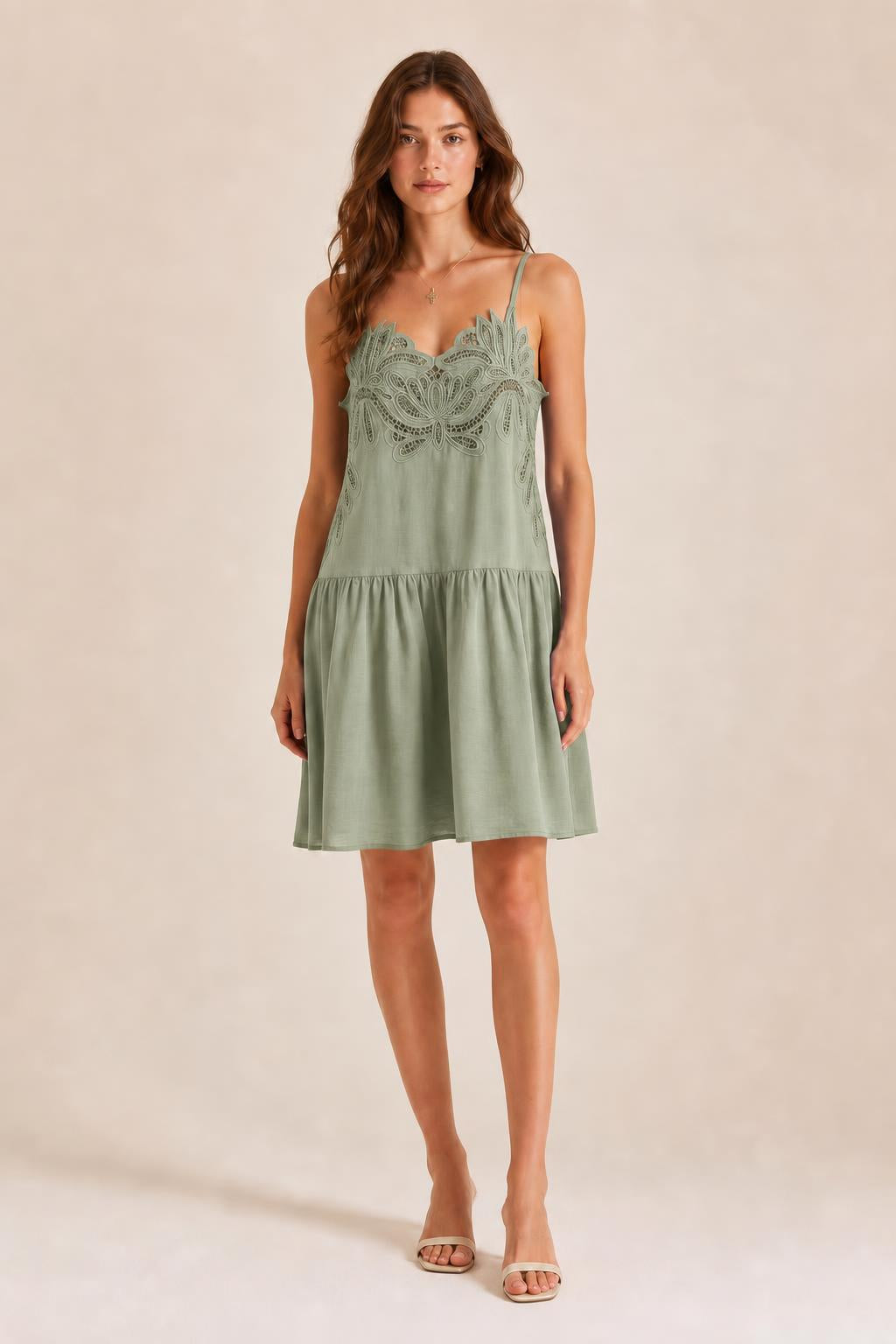 Front view of model in Sage Green embroidered cami mini dress
